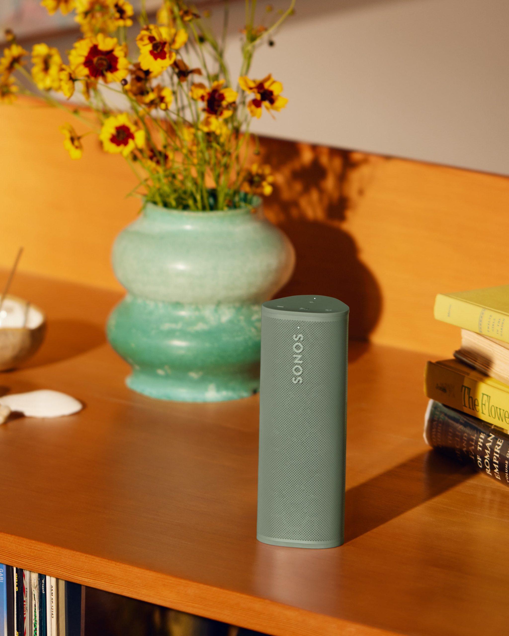 Sonos Roam 2 on credenza next to vase with flowers
