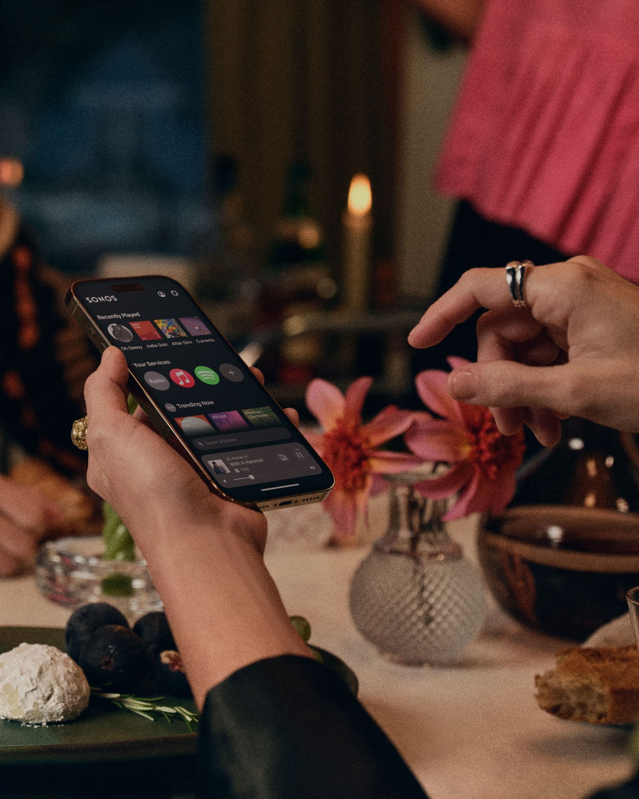 Person using Sonos app on smartphone